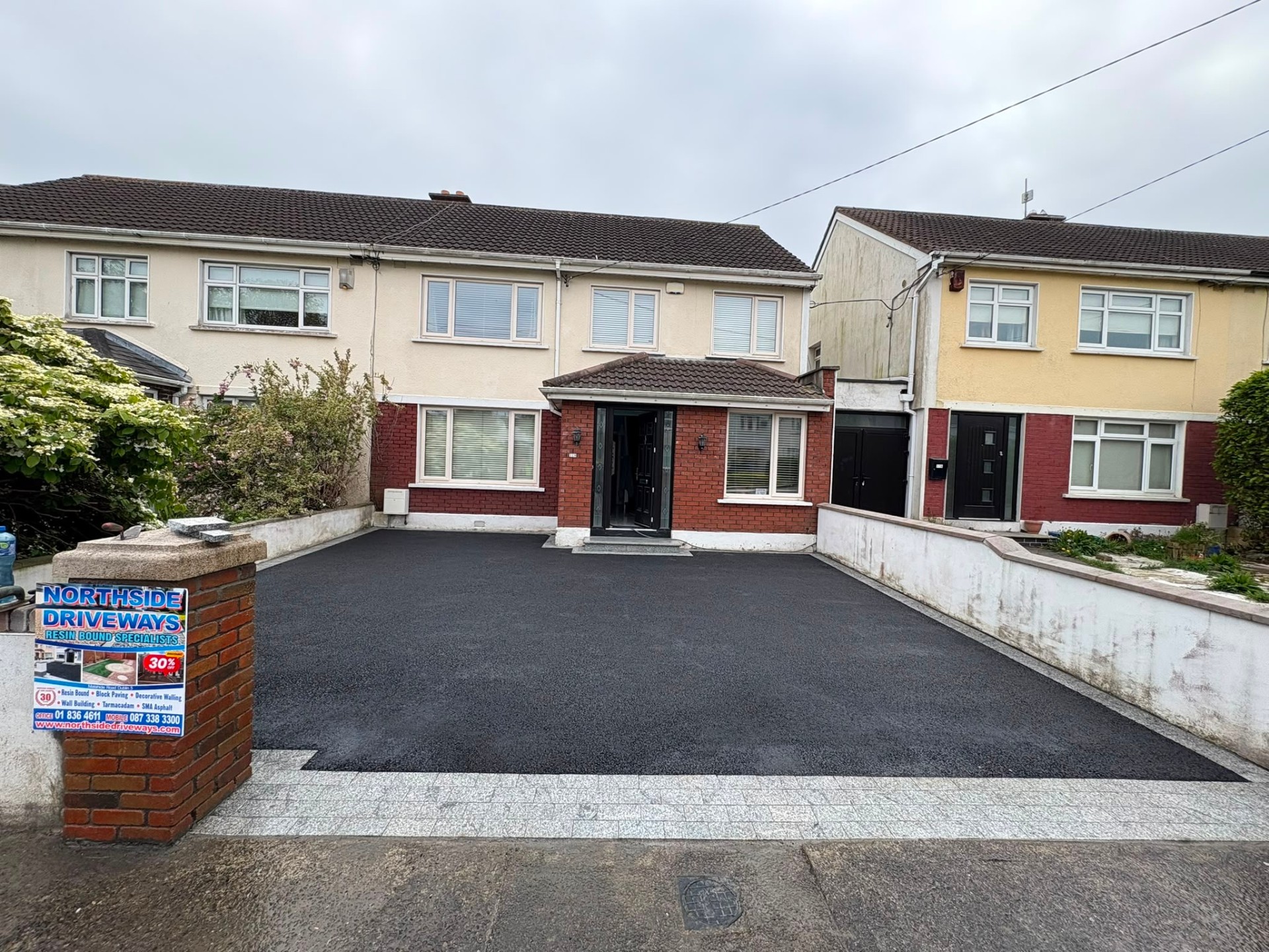 Freshly laid tarmac driveway with kerbed edging, North Dublin home